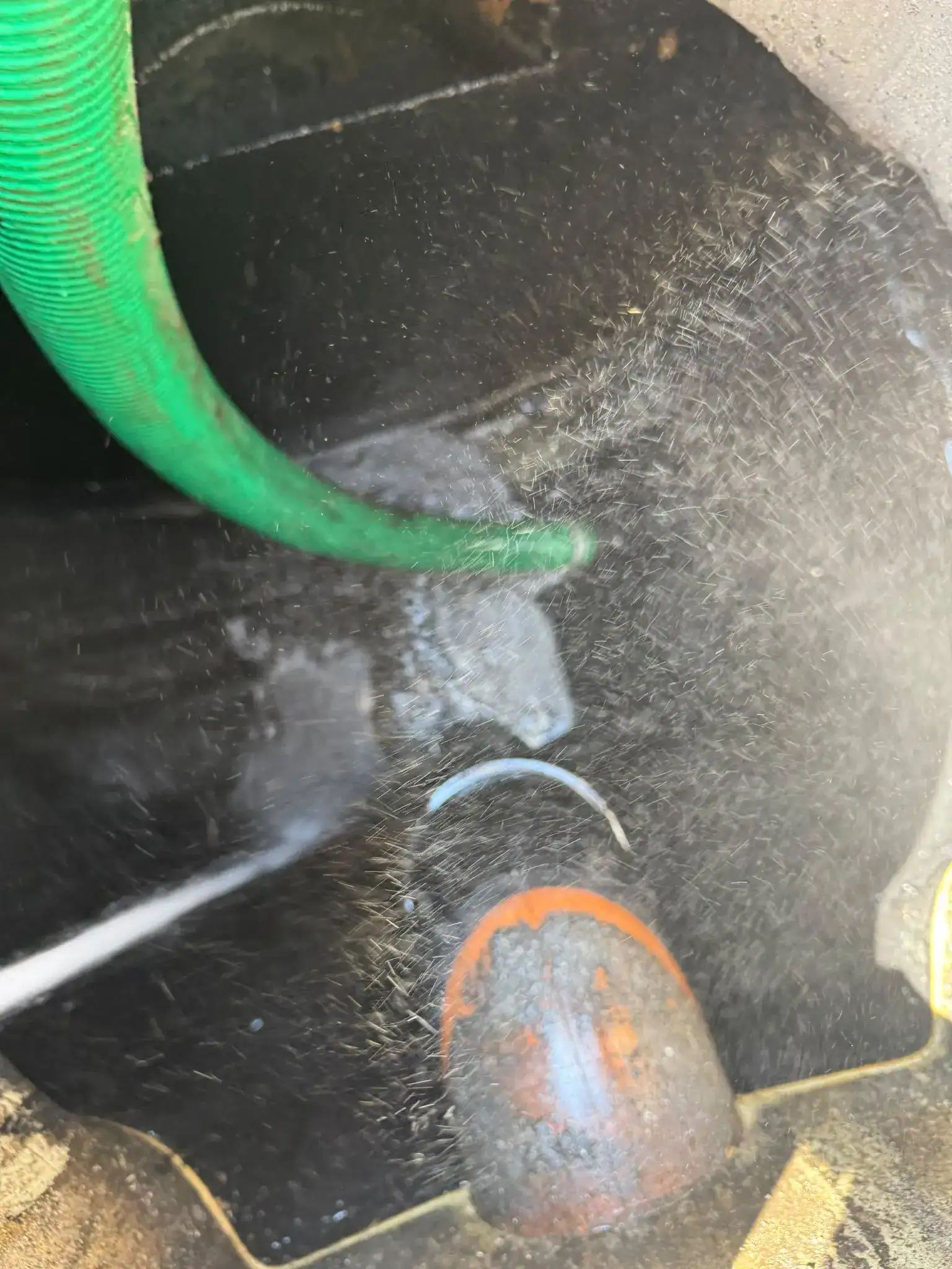 High pressure water jetting King’s Lynn drainage chamber cleaning with a suction hose removing wastewater.