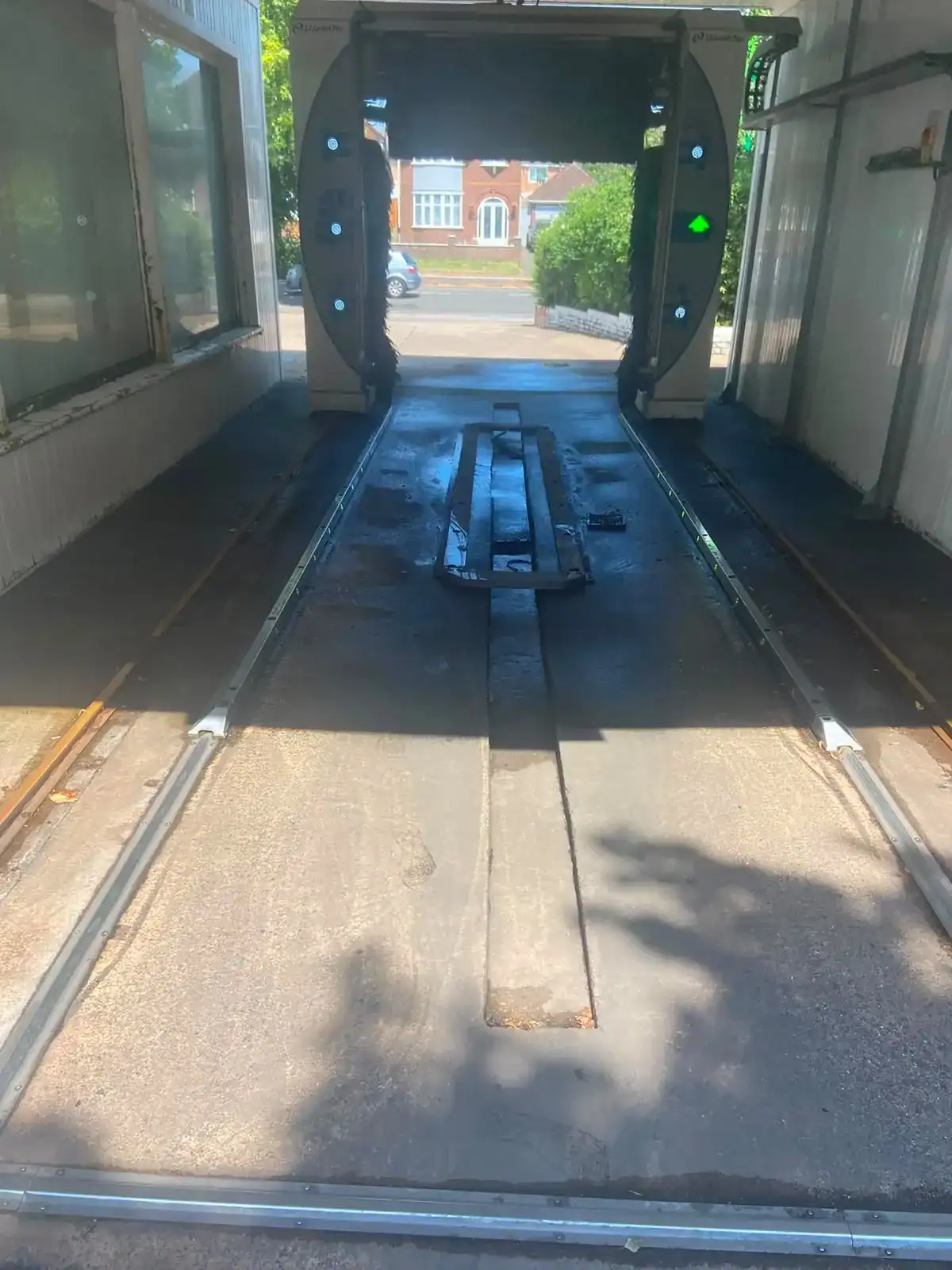 Commercial wash bay in North Runcton after emergency drain unblocking, with standing water cleared.