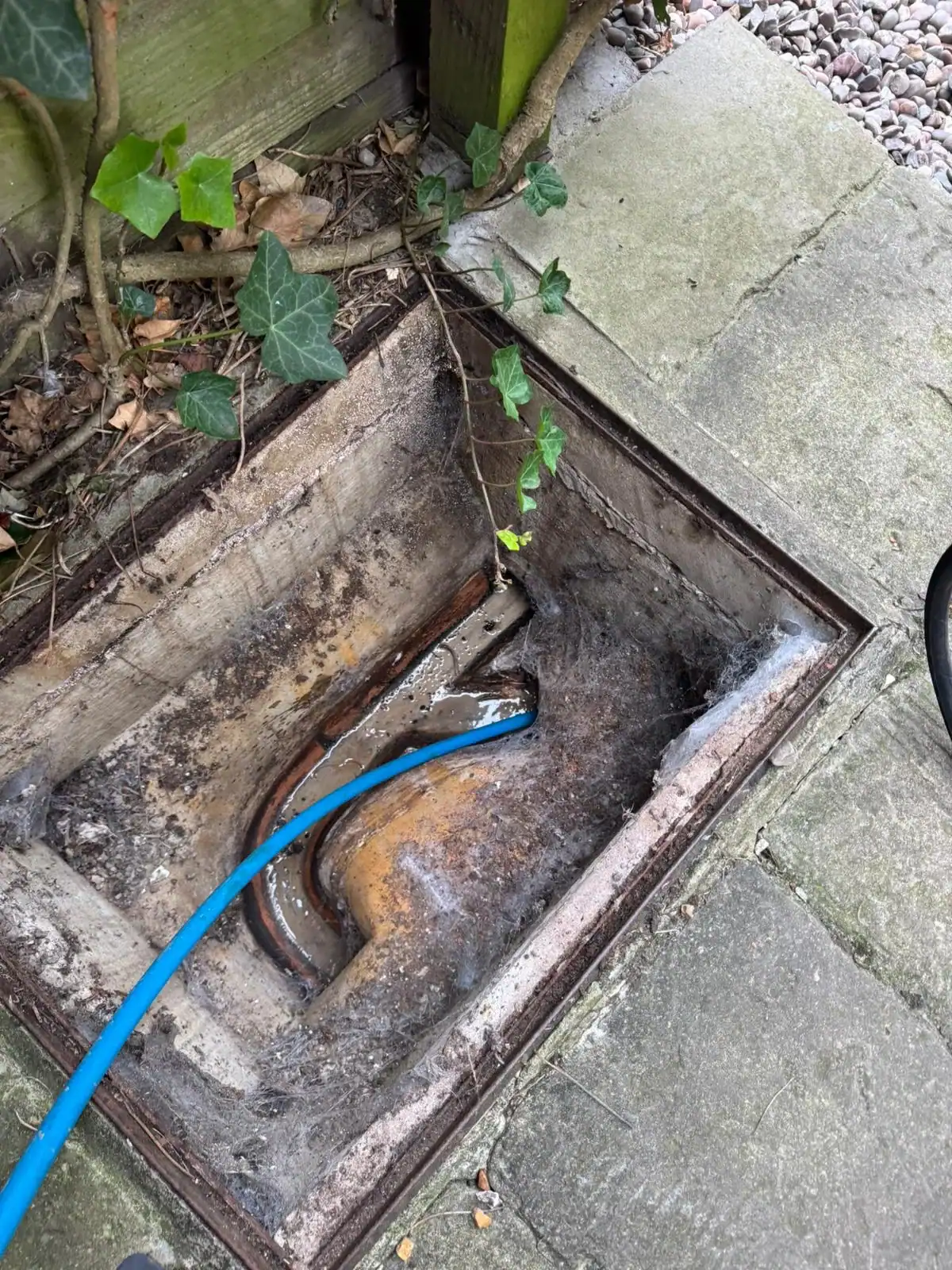 High-pressure jetting hose inside an inspection chamber during emergency drain unblocking in Setchey.