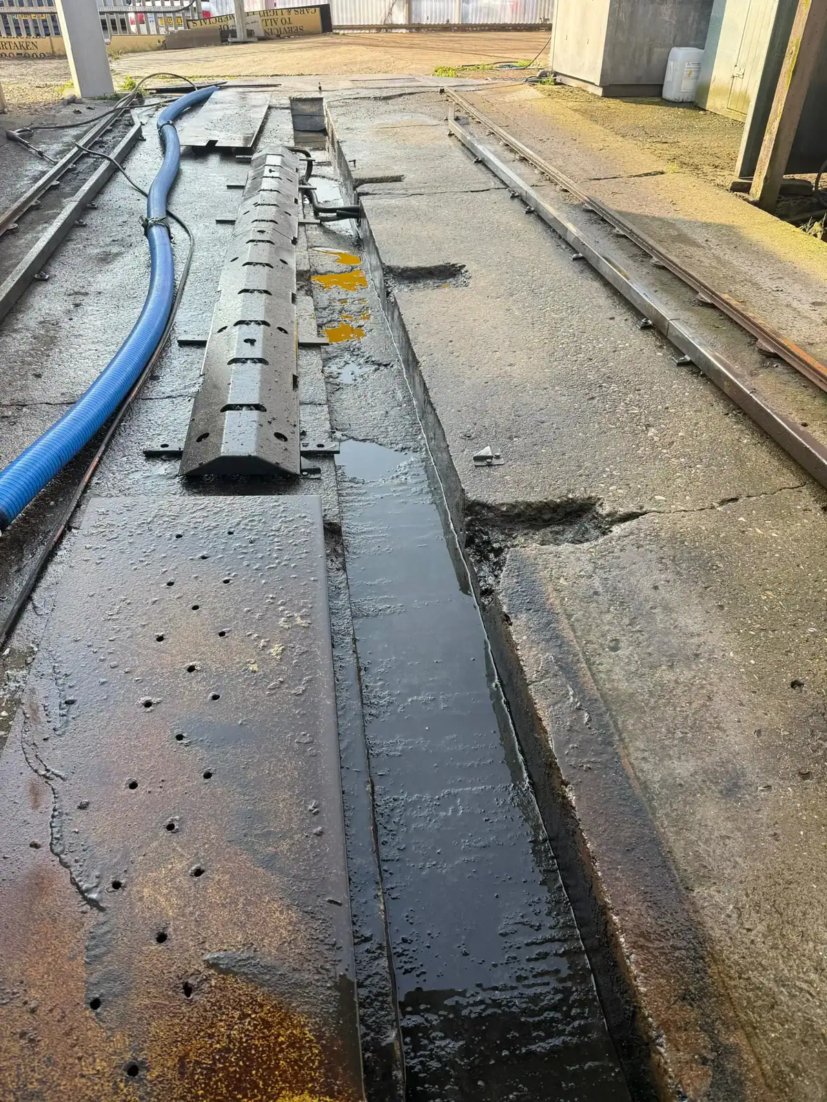 Commercial gully cleaning in King's Lynn with drainage channels opened and suction equipment in use.