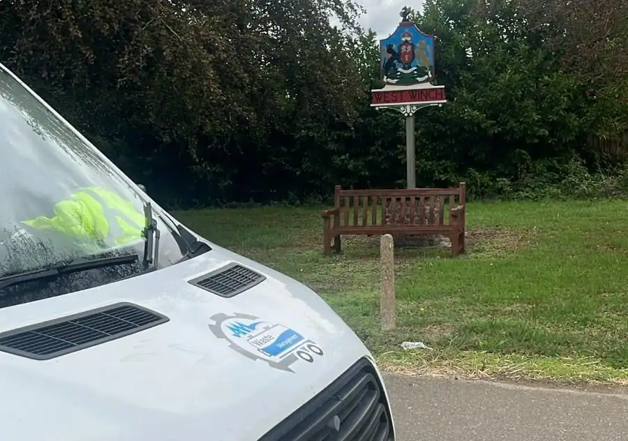 AM Waste Management van beside the West Winch village sign, covering Emergency Drain Unblocking in North Runcton in King's Lynn.