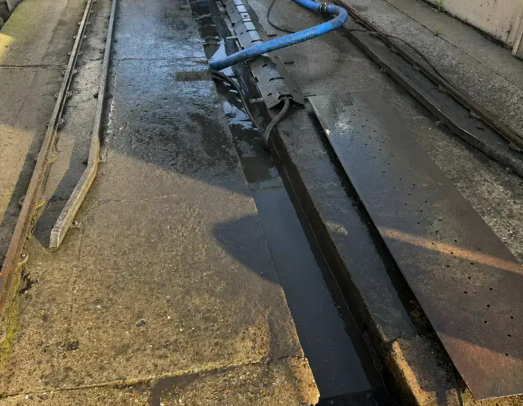 Emergency drain King's Lynn commercial drain clearance with vacuum tanker removing debris from an external drainage channel.